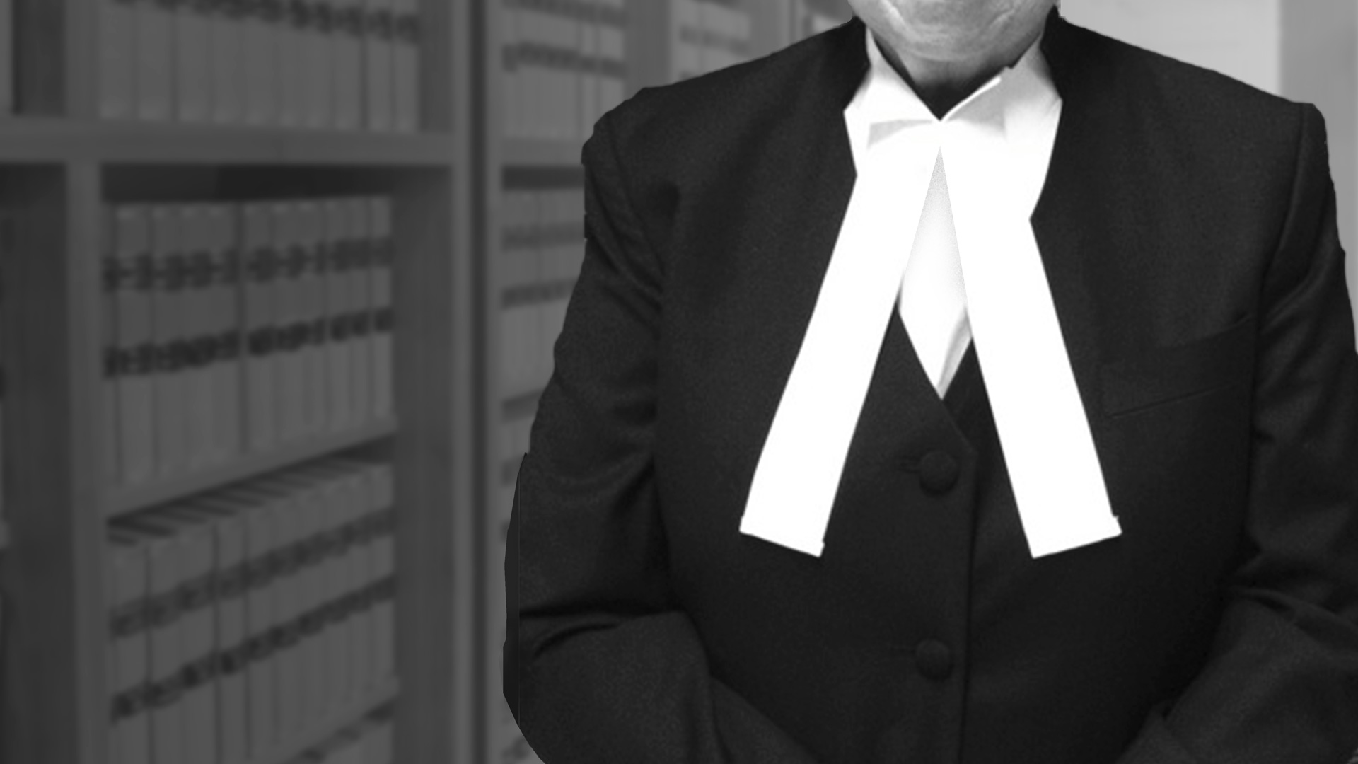 Our Barristers - photo of barrister standing in front of a bookcase